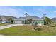 Charming single-story home with an attached garage, lush lawn, and patriotic flag at 321 Pessoa St, Punta Gorda, FL 33983