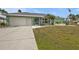 Charming single-story home with attached garage and well-manicured lawn at 321 Pessoa St, Punta Gorda, FL 33983