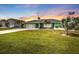 Charming single-story home with well-manicured lawn, tropical landscaping, and an American flag at 321 Pessoa St, Punta Gorda, FL 33983
