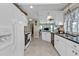 The modern kitchen boasts white cabinets, black countertops, and stainless steel appliances at 321 Pessoa St, Punta Gorda, FL 33983