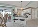 Modern kitchen featuring a breakfast bar with pendant lighting, white cabinetry, and a sliding glass door at 321 Pessoa St, Punta Gorda, FL 33983