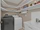 Functional laundry room with modern machines, sink, and ample shelving for storage at 321 Pessoa St, Punta Gorda, FL 33983