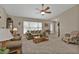Inviting living room with ceiling fan, large windows, comfortable furnishings, and neutral decor at 321 Pessoa St, Punta Gorda, FL 33983