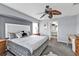 Comfortable main bedroom featuring ceiling fan, carpeted floors, and ensuite bathroom at 321 Pessoa St, Punta Gorda, FL 33983