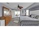 Comfortable main bedroom with carpet, wooden dresser, and access to the screened patio at 321 Pessoa St, Punta Gorda, FL 33983