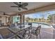 Covered patio with dining table, outdoor seating, and views of the pool and backyard at 321 Pessoa St, Punta Gorda, FL 33983
