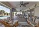 Covered patio with ceiling fans, dining table, outdoor seating, and views of the pool and backyard at 321 Pessoa St, Punta Gorda, FL 33983