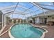 Screened-in pool area with wood-look decking and views of the backyard at 321 Pessoa St, Punta Gorda, FL 33983