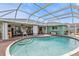 Screened-in pool area with wood-look decking, covered patio and views of the backyard at 321 Pessoa St, Punta Gorda, FL 33983