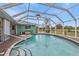 Screened-in pool area with wood-look decking and views of the backyard at 321 Pessoa St, Punta Gorda, FL 33983