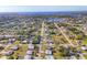 Expansive aerial view of a residential community near a scenic waterfront with lush greenery at 346 Cypress Nw Ave, Port Charlotte, FL 33952