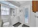 Well lit bathroom with toilet and sink, storage, and direct access to the pool at 366 Vitorio St, Punta Gorda, FL 33983