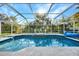 Inviting screened-in pool area with clear blue water, lush landscaping, and plenty of space for relaxation and entertaining at 366 Vitorio St, Punta Gorda, FL 33983