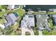 Aerial view of a property with a private pool, boat dock, and beautifully landscaped yard at 3906 Crooked Island Dr, Punta Gorda, FL 33950