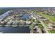 An aerial view of the community showing waterfront property with boat docks and manicured lawns at 3906 Crooked Island Dr, Punta Gorda, FL 33950