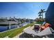 Waterfront backyard featuring a boat lift and outdoor seating with canal views, perfect for relaxing at 3906 Crooked Island Dr, Punta Gorda, FL 33950
