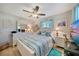 Bright bedroom with a turquoise rug, blue accents, and coastal decor at 3906 Crooked Island Dr, Punta Gorda, FL 33950