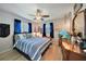 Cozy bedroom with nautical decor, a ceiling fan, and bright blue curtains for a relaxing atmosphere at 3906 Crooked Island Dr, Punta Gorda, FL 33950