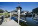 Boat and lift on a sunny day, offering convenient waterfront access for boating enthusiasts at 3906 Crooked Island Dr, Punta Gorda, FL 33950