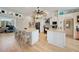 Eat-in kitchen featuring a large island, white cabinetry, modern appliances, and tile backsplash at 3906 Crooked Island Dr, Punta Gorda, FL 33950