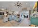 Bright living room with an open floor plan, ceiling fan, and view of dining room and kitchen at 3906 Crooked Island Dr, Punta Gorda, FL 33950
