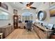 Well-lit home office space featuring hardwood floors, custom shelving, and large windows at 3906 Crooked Island Dr, Punta Gorda, FL 33950