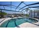 Screened-in pool with waterfront views and outdoor seating area, perfect for relaxation and entertaining at 3906 Crooked Island Dr, Punta Gorda, FL 33950