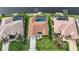 Overhead shot displaying the house's backyard pool, well-manicured lawn, and lush tropical foliage and a canal view at 3961 San Pietro Ct, Punta Gorda, FL 33950
