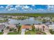 Aerial view showcasing a waterfront home with lush landscaping, situated on a canal, offering picturesque water access at 3961 San Pietro Ct, Punta Gorda, FL 33950