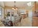 The breakfast nook features a glass-top table and leads into a kitchen with an island at 3961 San Pietro Ct, Punta Gorda, FL 33950