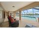 Covered lanai showing seating area with pool and canal view at 3961 San Pietro Ct, Punta Gorda, FL 33950