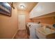 Well-equipped laundry room with modern washer and dryer, sink, and storage cabinets at 3961 San Pietro Ct, Punta Gorda, FL 33950
