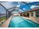 Screened in swimming pool with view of lanai and canal at 3961 San Pietro Ct, Punta Gorda, FL 33950