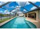 Screened in swimming pool with view of lanai and canal at 3961 San Pietro Ct, Punta Gorda, FL 33950
