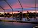 Beautiful waterfront sunset view from the lanai, reflected in the still water, creating a serene and picturesque scene at 3961 San Pietro Ct, Punta Gorda, FL 33950