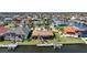 Waterfront home featuring a screened lanai, private dock, and lush landscaping in a vibrant neighborhood at 413 Valletta Ct, Punta Gorda, FL 33950