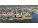A panoramic aerial perspective showcases waterfront homes with boat docks in a beautiful community, and golf course at 413 Valletta Ct, Punta Gorda, FL 33950