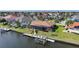 Waterfront home featuring a private dock with boat lift, and lush landscaping in a vibrant neighborhood at 413 Valletta Ct, Punta Gorda, FL 33950