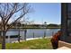 The backyard view features a canal, boat lift, sailboat and homes in the distance at 413 Valletta Ct, Punta Gorda, FL 33950