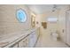 Bright bathroom featuring marble counters, octagon window, and ceramic tile at 413 Valletta Ct, Punta Gorda, FL 33950