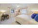 Bright bedroom featuring a ceiling fan, large windows and an antique clock at 413 Valletta Ct, Punta Gorda, FL 33950