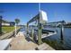 Canal-front property featuring a private boat lift and dock, perfect for boating enthusiasts and waterfront living at 413 Valletta Ct, Punta Gorda, FL 33950