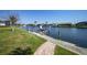 Backyard with a dock and boat lift leading to a canal with waterfront homes at 413 Valletta Ct, Punta Gorda, FL 33950