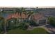 Inviting single-story home with lush landscaping, a tile roof, a two-car garage, and canal views at 413 Valletta Ct, Punta Gorda, FL 33950