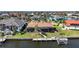 Waterfront home featuring a private boat dock and large screened lanai for outdoor living at 413 Valletta Ct, Punta Gorda, FL 33950
