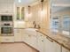 Bright kitchen featuring white cabinets, stainless steel appliances, and granite countertops at 413 Valletta Ct, Punta Gorda, FL 33950