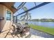 Screened lanai with waterfront views, featuring a table and four chairs at 413 Valletta Ct, Punta Gorda, FL 33950
