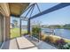 Screened lanai with a view of the canal and a boat lift at 413 Valletta Ct, Punta Gorda, FL 33950