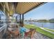 Covered lanai featuring four wicker chairs, a small table and a scenic canal view at 413 Valletta Ct, Punta Gorda, FL 33950