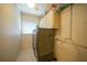 Laundry room with front load washer and dryer, storage cabinets, and a window at 413 Valletta Ct, Punta Gorda, FL 33950
